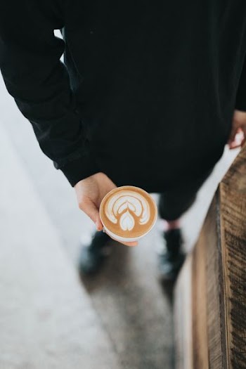person holding cup filled with coffee