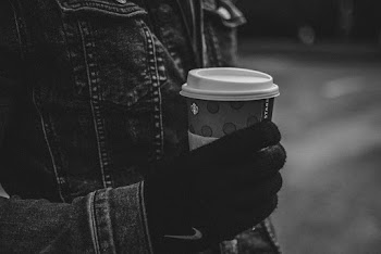 Person Holding Disposable Cup With Lid 