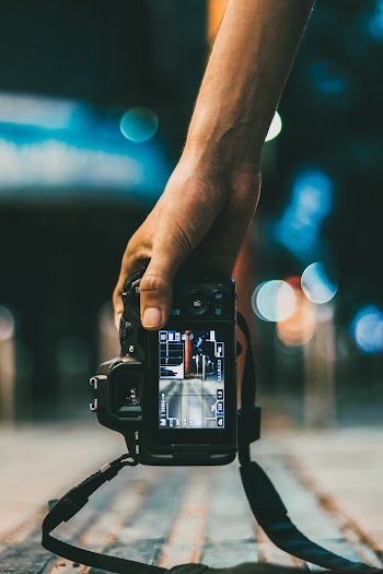 Person Holding Dslr Camera
