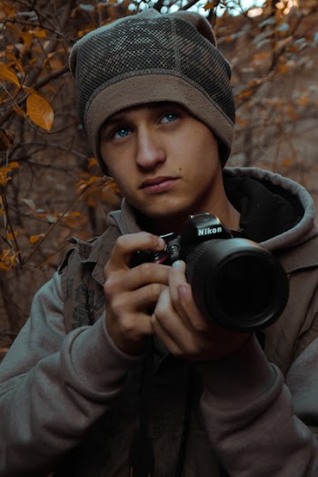 Person Holding Dslr Camera In Shallow Photo