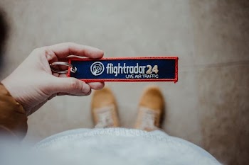 person holding Flightradar 24 card