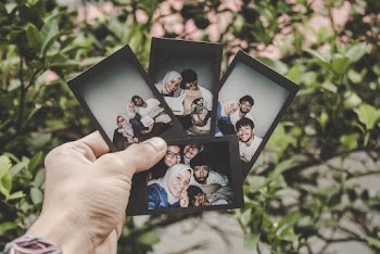 Person Holding Four Family Pictures