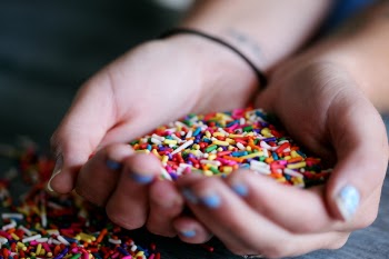 Person Holding Full of Sprinkles
