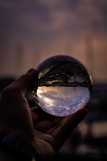 Person Holding Glass Ball