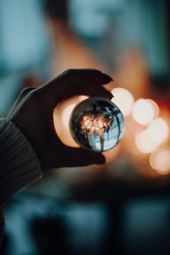 Person Holding Glass Ball