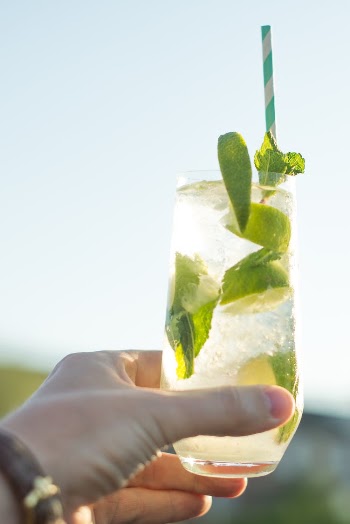 Person Holding Glass Filled With Lemonade