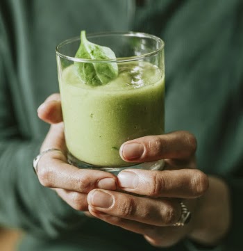 Person Holding Glass Of Vegetable Shake
