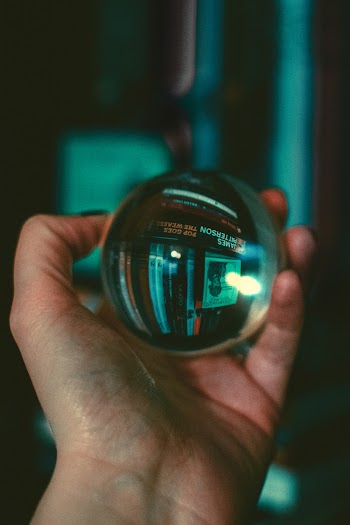 Person Holding Glass Sphere