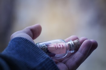 Person Holding Glass Vial