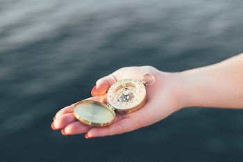 person holding gold-colored pocket watch