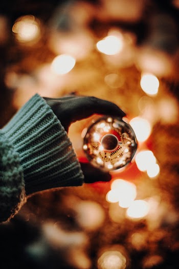 Person Holding Gray Bauble