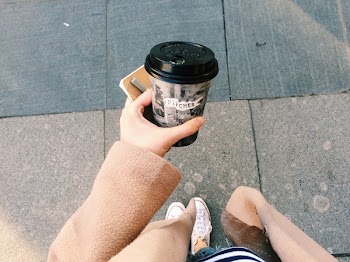 Person Holding Gray Disposable Cup