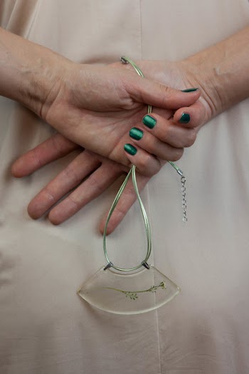 Person Holding Green Necklace