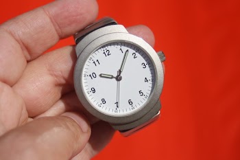 Person Holding Grey Round Analog Watch at 10:07