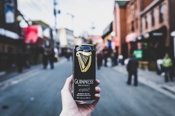 person holding Guinness can