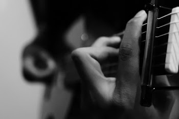 Person Holding Guitar in Grayscale Photography
