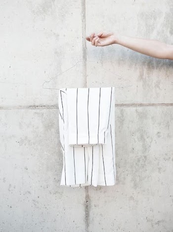 person holding hanger with white shorts