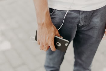 Person Holding Iphone With Black Case