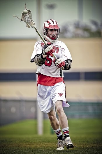Person Holding Lacrosse Stick during Daytime
