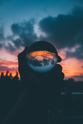 Person Holding Lensball During Golden Hour
