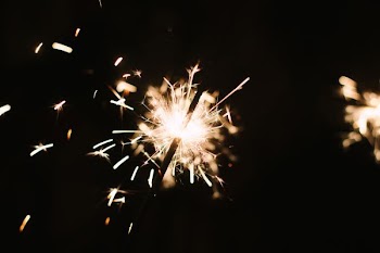 person holding lighted sparkler