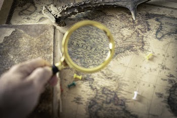 Person Holding Magnifying Glass