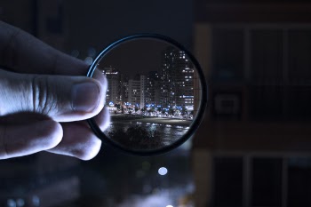 Person Holding Magnifying Glass