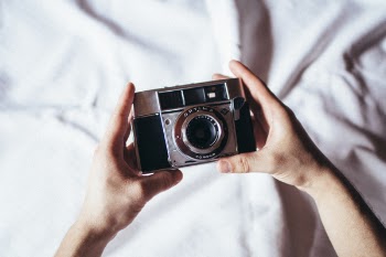 Person Holding Milc Camera