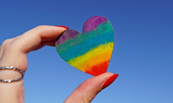 Person Holding Multicolored Heart Decor