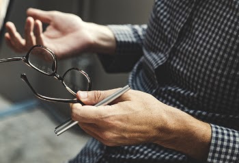 Person Holding of Clear Eyeglasses With Black Frames