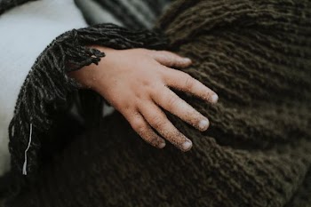 person holding on gray crochet textile