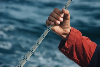 Person Holding on Rope