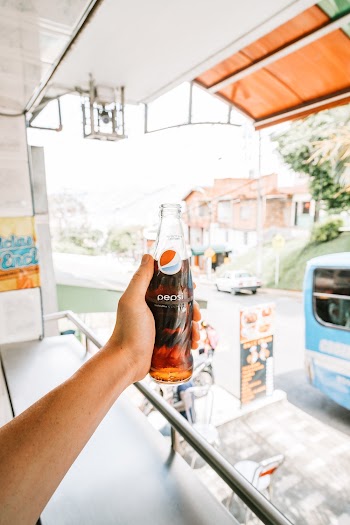 Person Holding Open Pepsi Glass Bottle