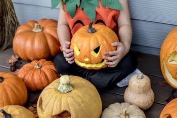 Person Holding Orange and Yellow Jack-o'-lantern