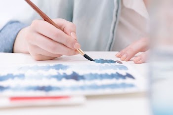 person holding paint brush