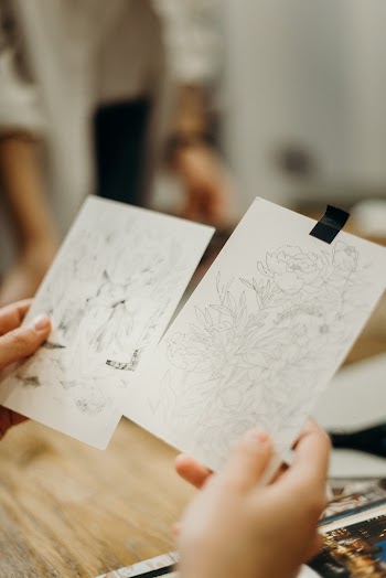 Person Holding Paper Sketch