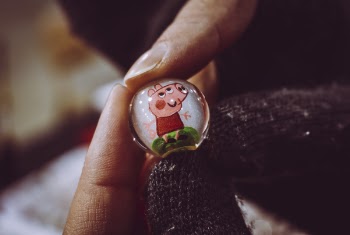 Person Holding Peppa Pig Toy Marble