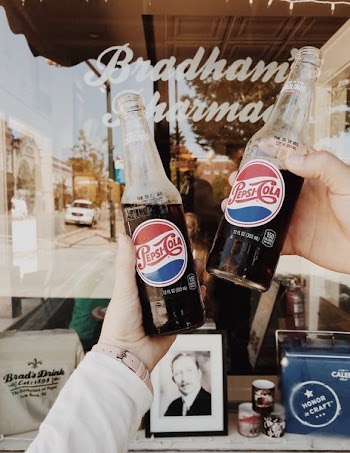 person holding Pepsi Cola soda bottles