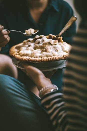 Person Holding Pie And Spoon