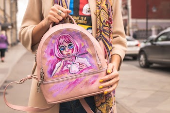 Person Holding Pink Backpack