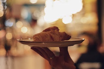 Person Holding Plate of Pastry