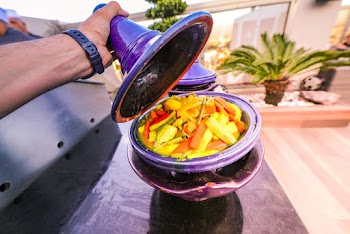 Person Holding Purple Ceramic Lid