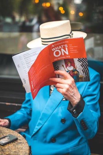 person holding red book