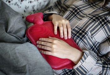 Person Holding Red Hot Compress