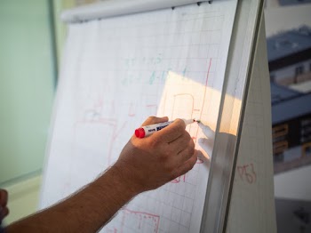 Person Holding Red Marker Pen