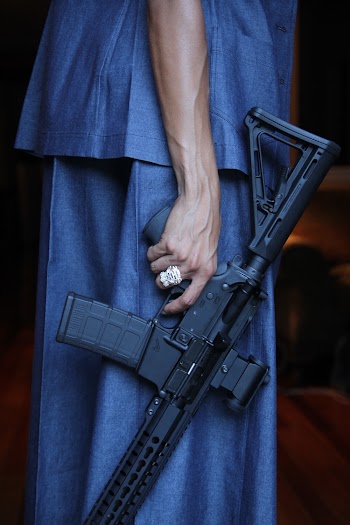 Person Holding Rifle