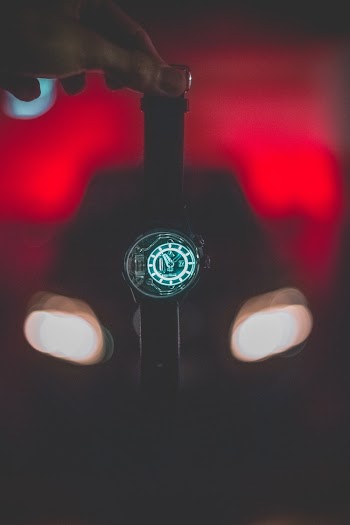 Person Holding Round Black Digital Watch With Black Band