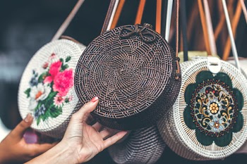 Person Holding Round Black Wicker Crossbody Bag