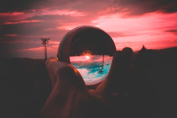 Person Holding Round Clear Glass Decor
