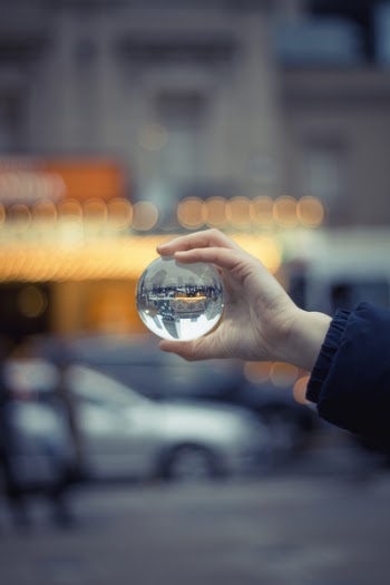 Person Holding Round Glass Ball Macro Shot
